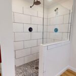 Polished Carera Tile w/ Black Pebble Floor 